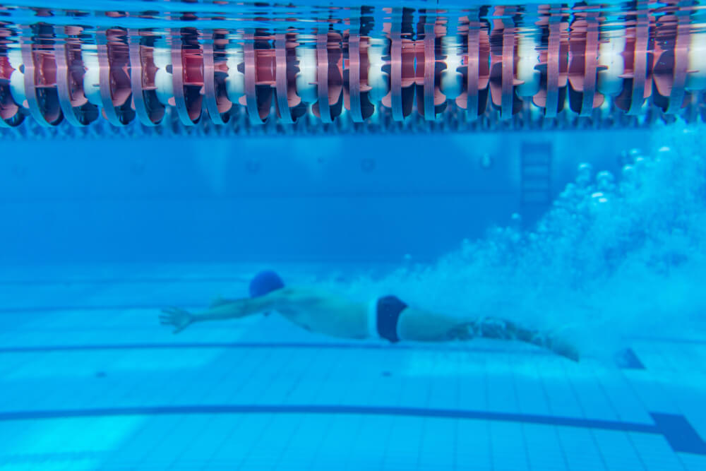 Young Swimmer Exercising in Swimming Pool